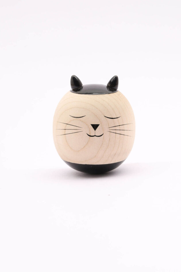 An image of the Wooden Roly Poly Toy with a friendly cat face for babies by Bumshum, a nature-friendly store for kids. The toy is made from natural wood and designed for sensory engagement and imaginative play.
